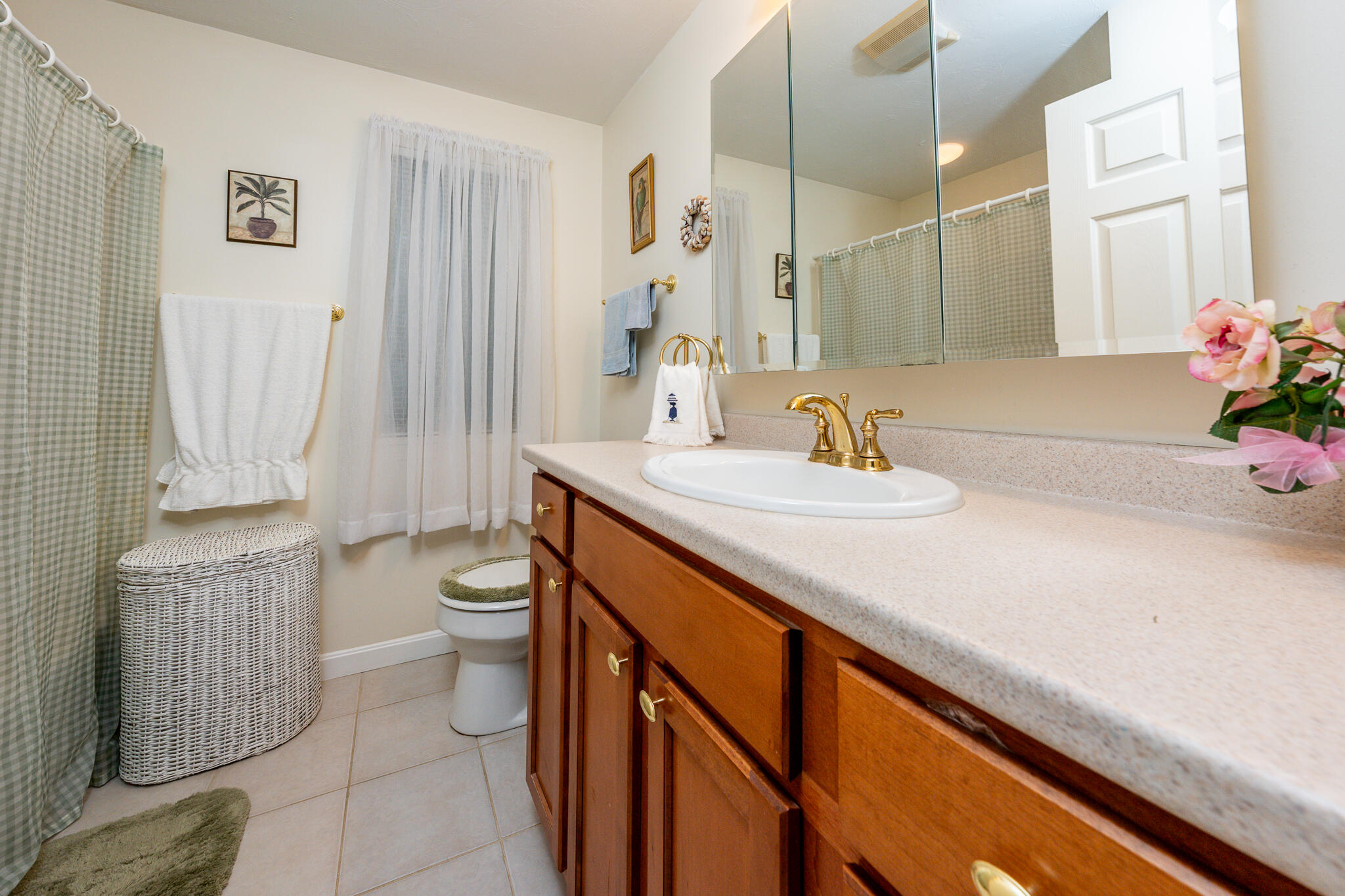 7 Masters Court Mashpee, MA 02649 - Photo 18 of 34 a bathroom with a sink a toilet and shower curtain