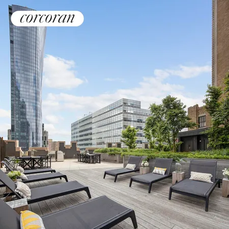 a lobby with furniture and chandelier