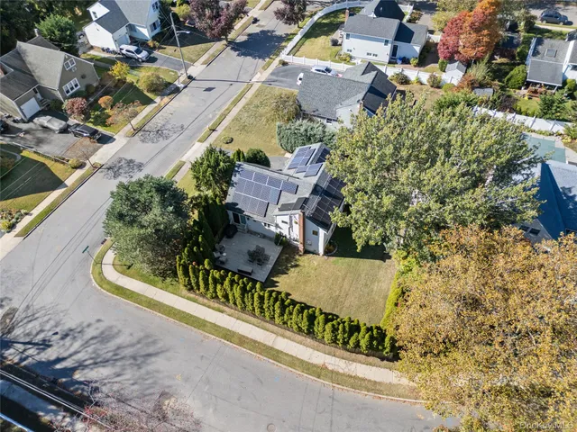 an aerial view of a house with a garden and parking