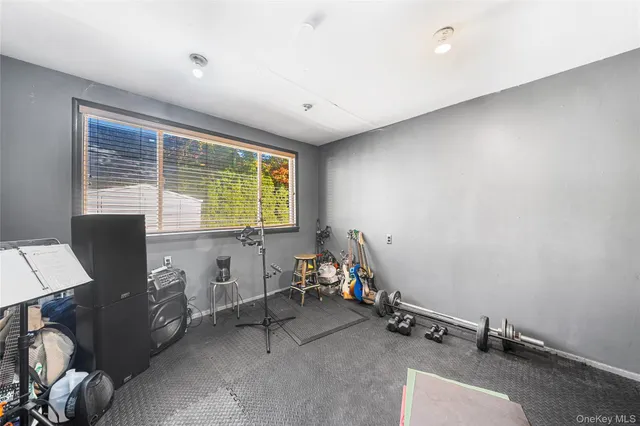 a room with gym equipment and a window