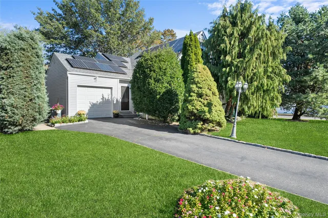 a backyard of a house with lots of green space and fountain