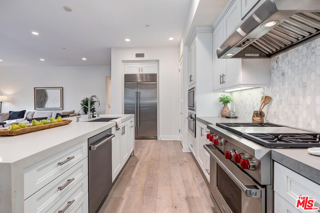 12771 Shell Place, Unit 2 Los Angeles, CA 90094 - Photo 14 of 39 a kitchen with stainless steel appliances granite countertop a stove and a sink