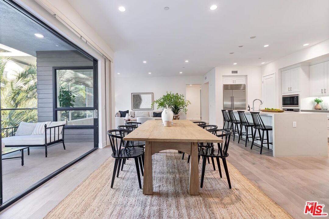 12771 Shell Place, Unit 2 Los Angeles, CA 90094 - Photo 16 of 39 a view of a dining room with furniture window and wooden floor