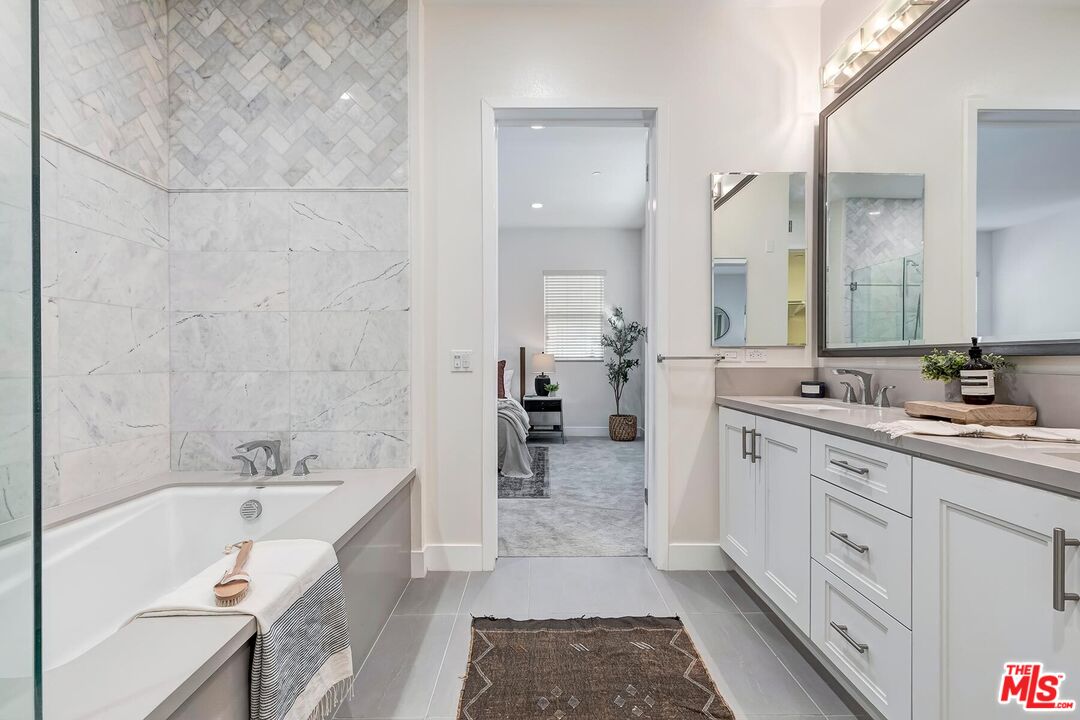 12771 Shell Place, Unit 2 Los Angeles, CA 90094 - Photo 27 of 39 a large spacious bathroom with a tub sink and mirror