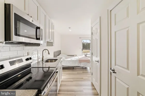 a kitchen with sink a refrigerator and cabinets