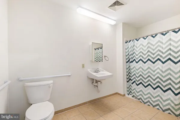 a large bathroom with a tub a sink and a large mirror