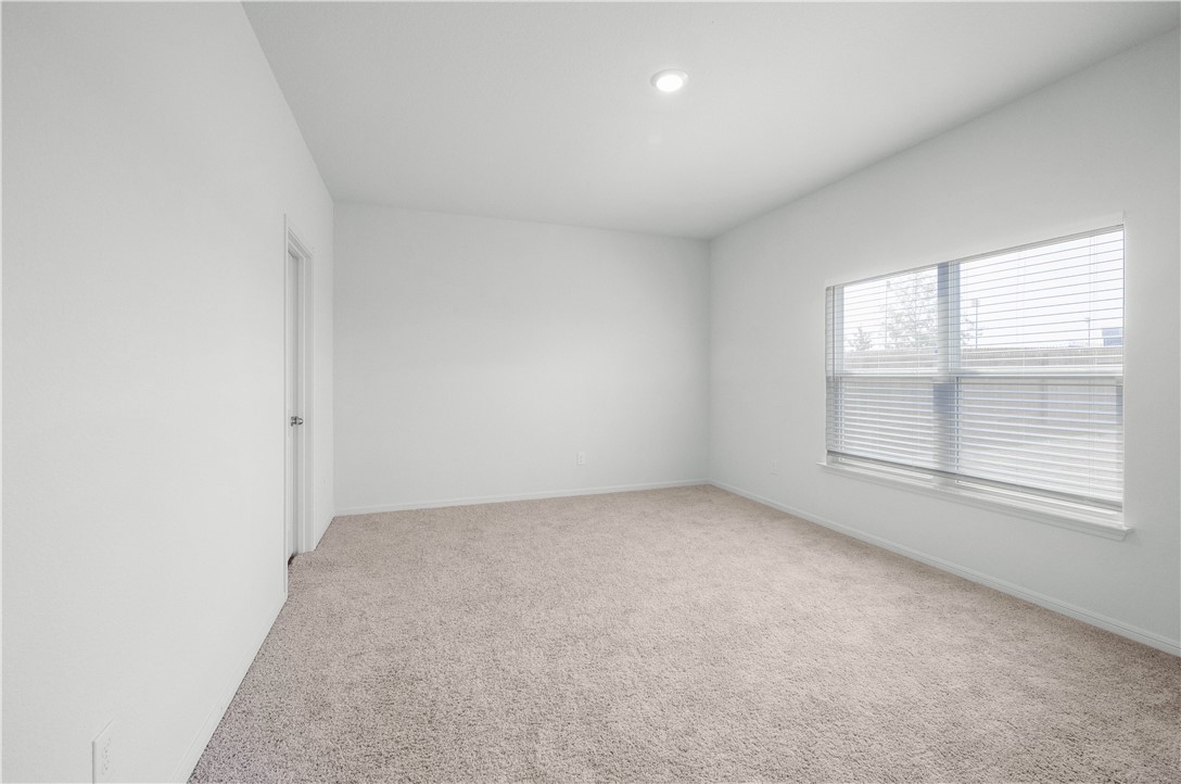 18513 Quiet Range Drive Elgin, TX 78621 - Photo 11 of 28 an empty room with a window
