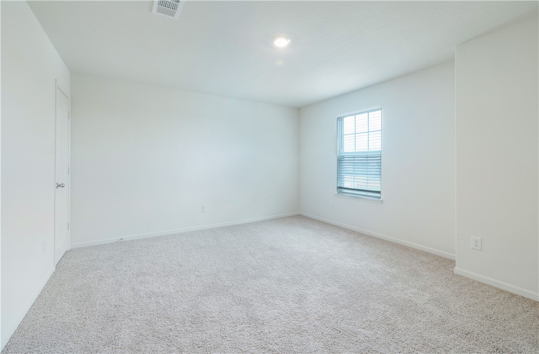 18513 Quiet Range Drive Elgin, TX 78621 - Photo 16 of 28 an empty room with windows