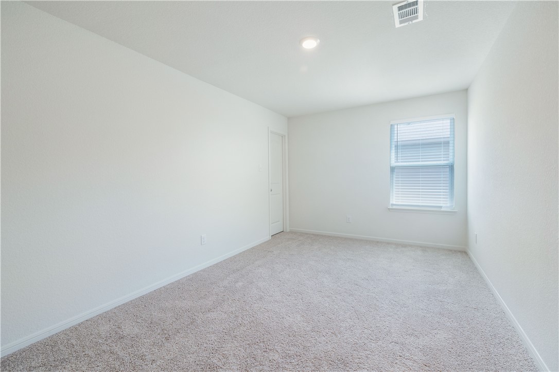 18513 Quiet Range Drive Elgin, TX 78621 - Photo 18 of 28 an empty room with a empty space and window