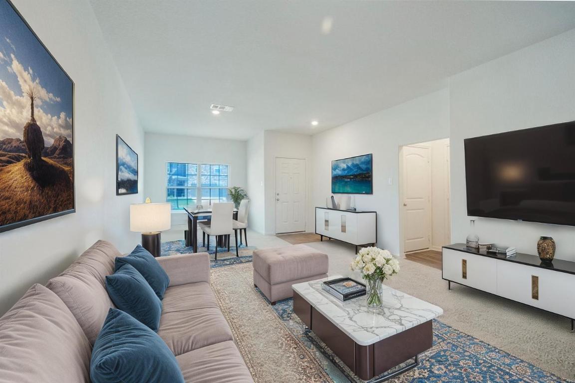 18513 Quiet Range Drive Elgin, TX 78621 - Photo 2 of 28 a living room with furniture and a flat screen tv