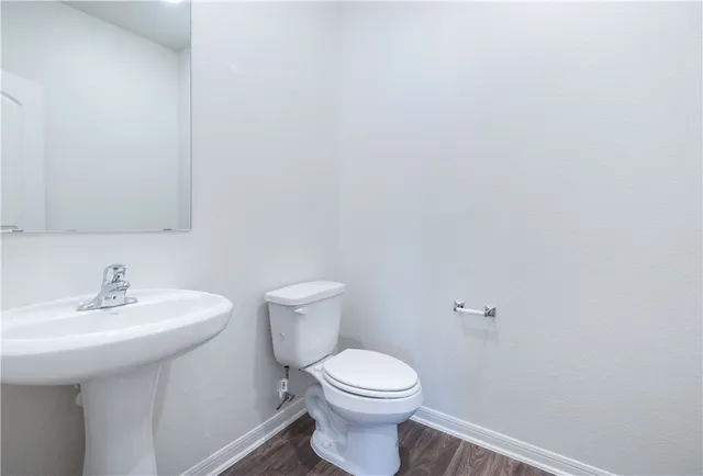 a bathroom with a sink a toilet and mirror