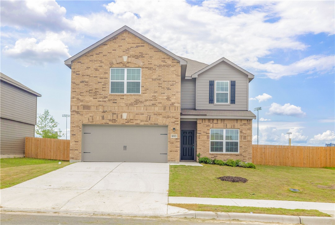 18513 Quiet Range Drive Elgin, TX 78621 - Photo 25 of 28 a front view of a house with a garden
