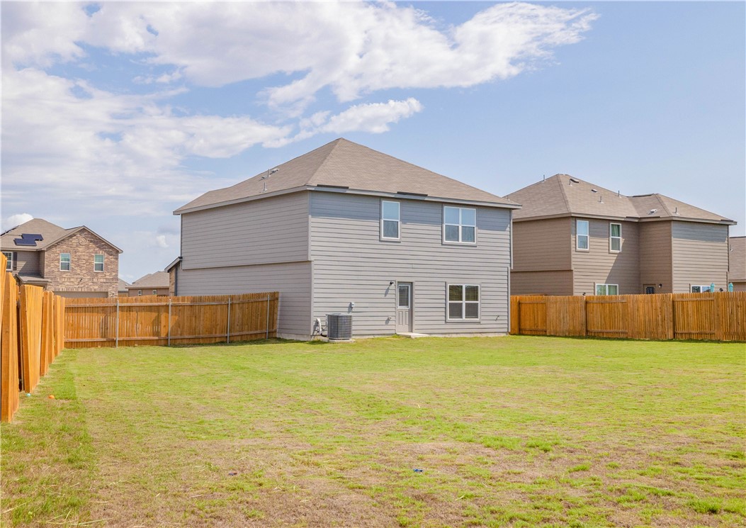 18513 Quiet Range Drive Elgin, TX 78621 - Photo 27 of 28 a view of a house with a yard and a large tree