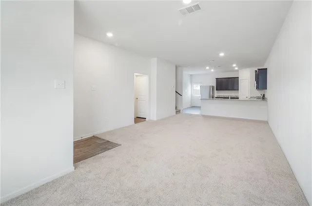 a view of a kitchen with a sink and a refrigerator