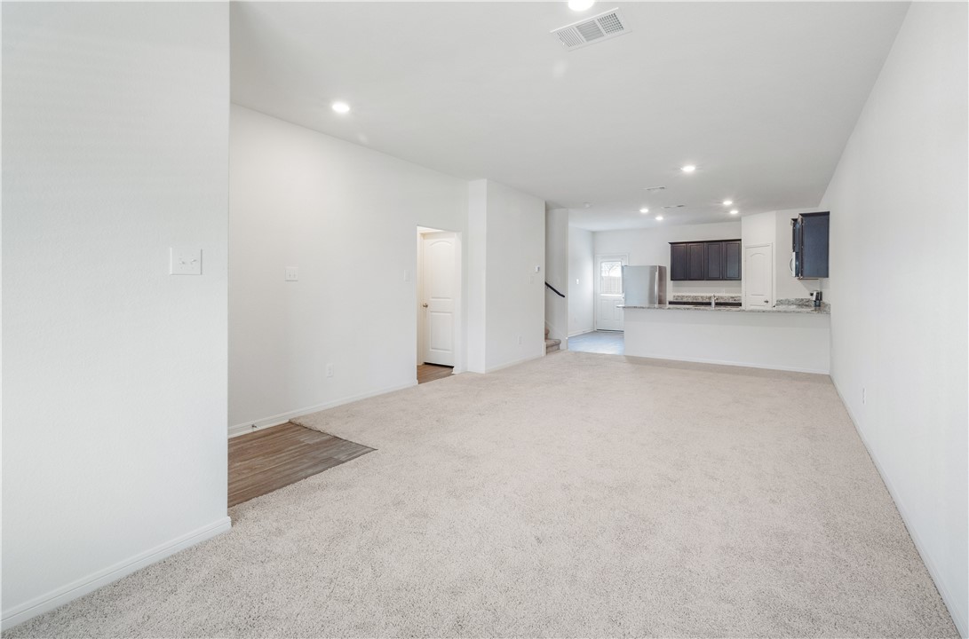 18513 Quiet Range Drive Elgin, TX 78621 - Photo 5 of 28 a view of a kitchen with a sink and a refrigerator