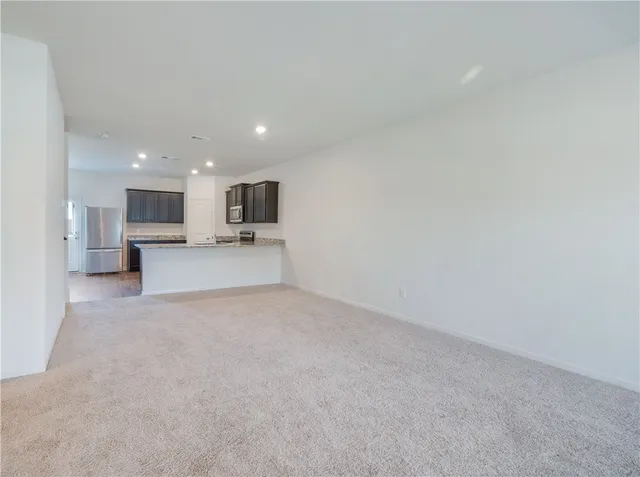 a view of a livingroom and a fireplace in a kitchen