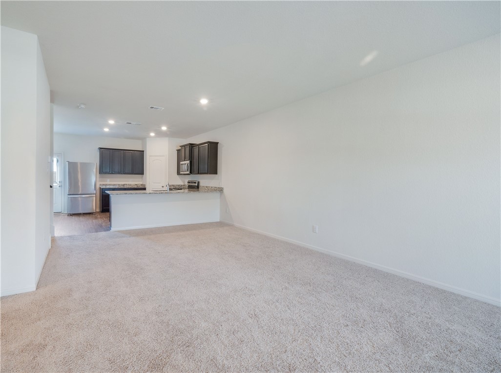 18513 Quiet Range Drive Elgin, TX 78621 - Photo 6 of 28 a view of a livingroom and a fireplace in a kitchen