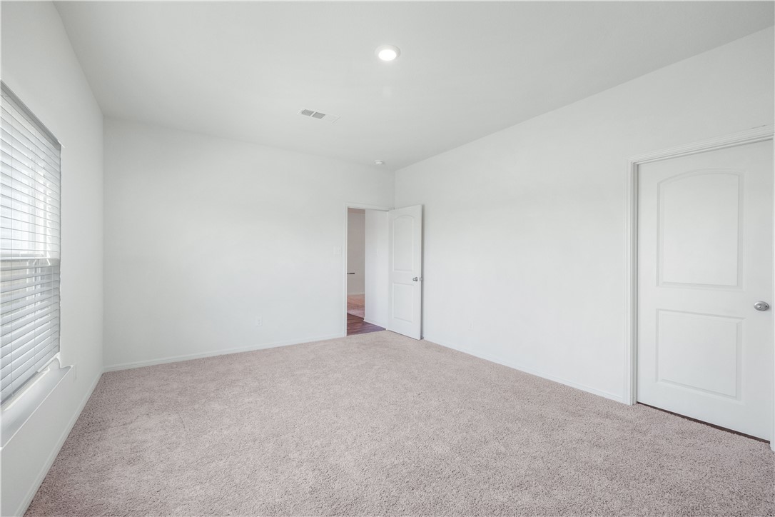 18513 Quiet Range Drive Elgin, TX 78621 - Photo 10 of 28 an empty room with windows and closet