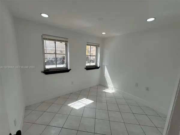 a white toilet sitting next to a bathroom sink and a shower