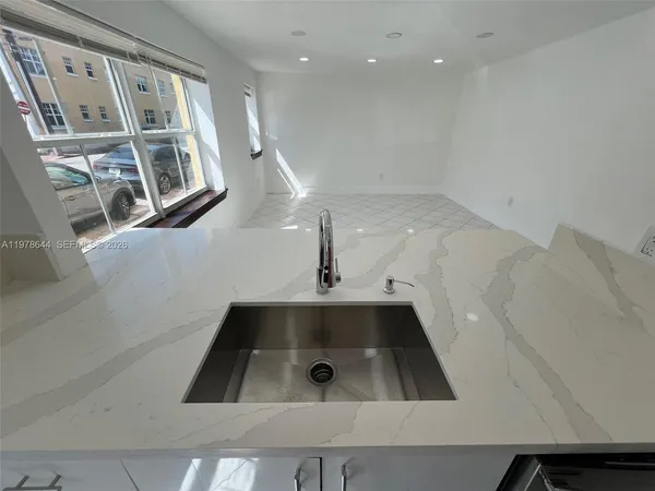 a kitchen with a stove cabinets and a window