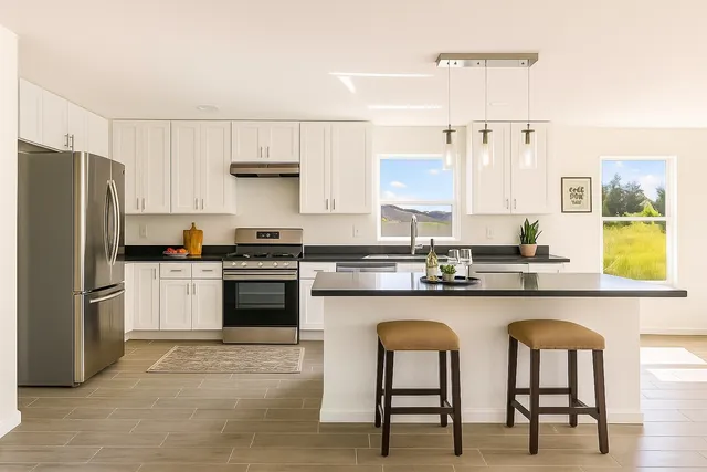 a kitchen with stainless steel appliances granite countertop a white cabinets and a stove