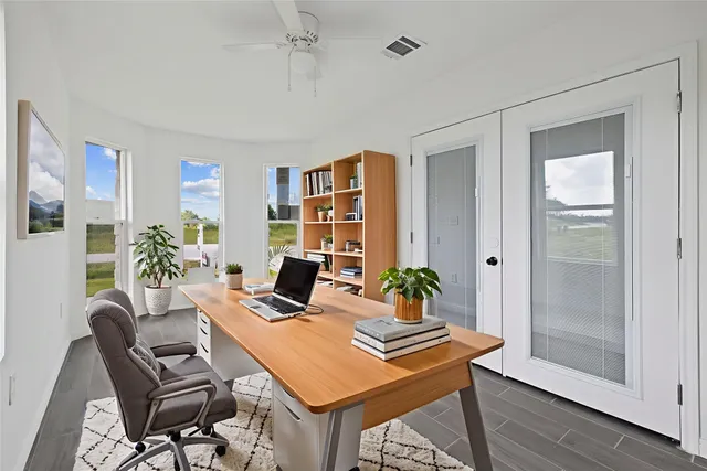 a view of a workspace with furniture and a potted plant