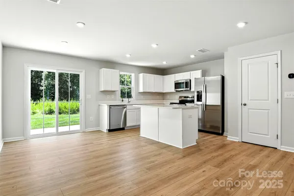 a kitchen with a refrigerator and a sink