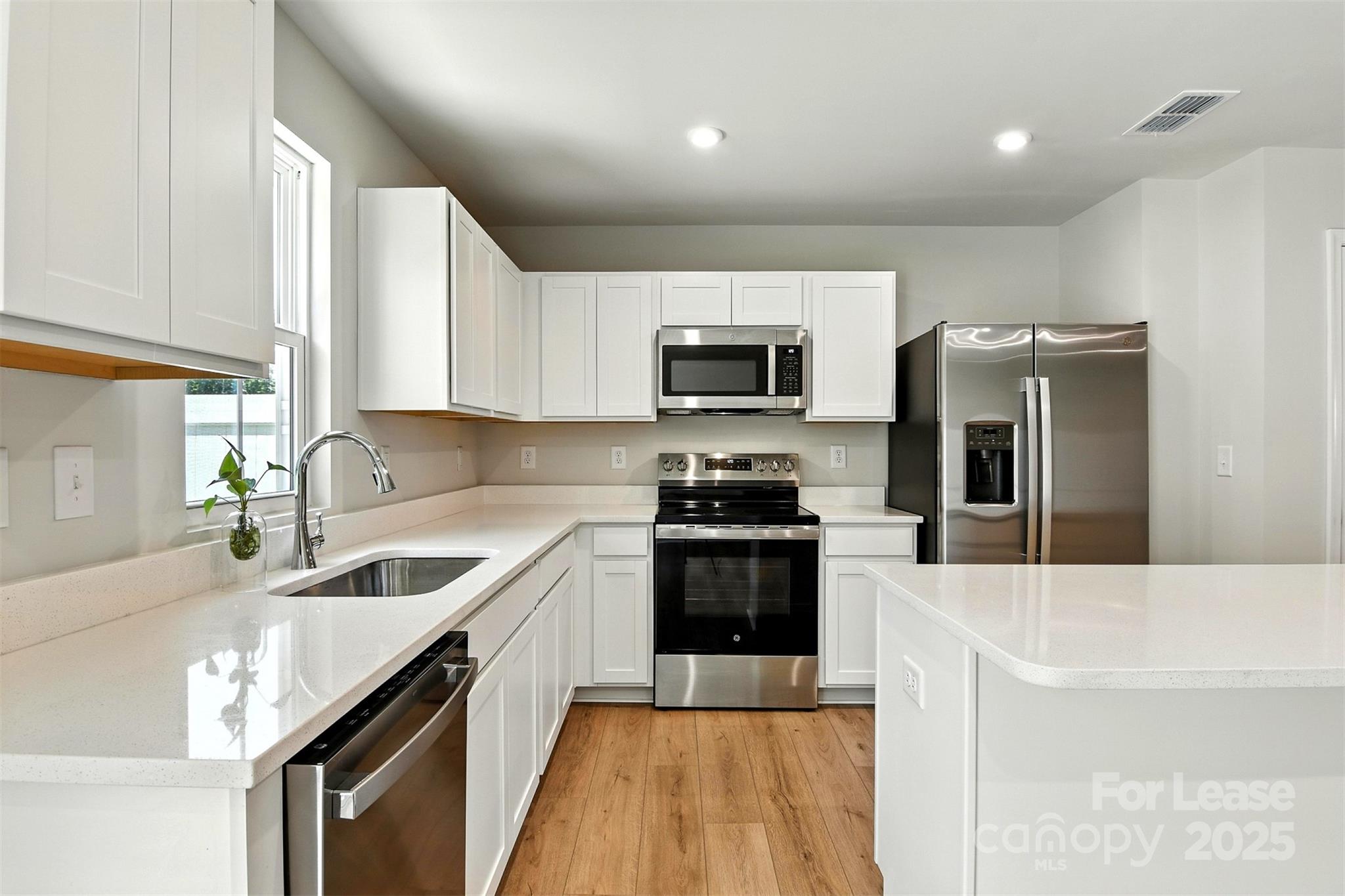 1525 39th Ave Loop Northeast Hickory, NC 28601 - Photo 7 of 24 a kitchen with granite countertop a sink a counter space appliances and cabinets