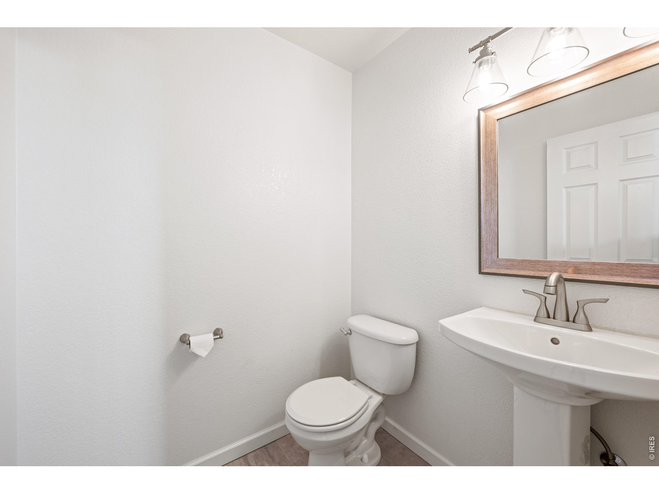 9877 Buffalo Street Firestone, CO 80504 - Photo 16 of 40 a bathroom with a toilet sink and mirror