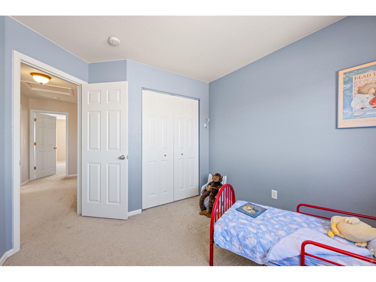 9877 Buffalo Street Firestone, CO 80504 - Photo 25 of 40 a bedroom with a bed and a chandelier