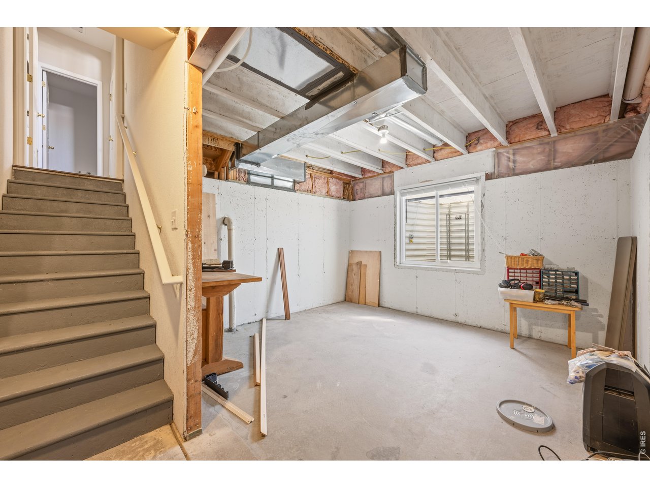9877 Buffalo Street Firestone, CO 80504 - Photo 29 of 40 a view of an empty room with wooden floor and stairs