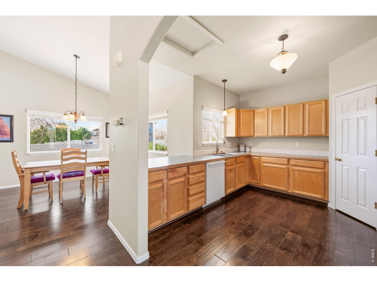 9877 Buffalo Street Firestone, CO 80504 - Photo 40 of 40 a kitchen with a table chairs sink and cabinets