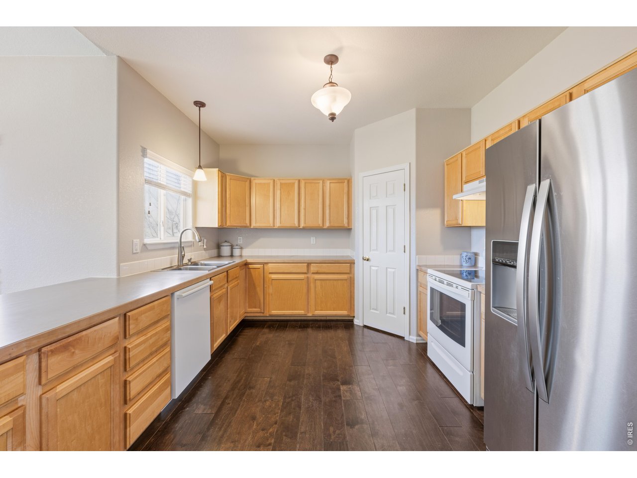 9877 Buffalo Street Firestone, CO 80504 - Photo 6 of 40 a kitchen with a refrigerator sink and cabinets