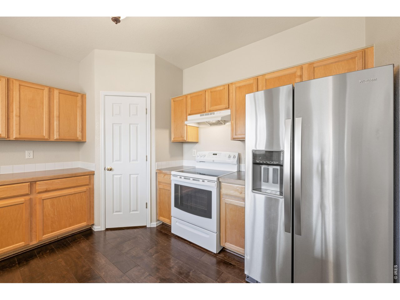 9877 Buffalo Street Firestone, CO 80504 - Photo 7 of 40 a kitchen with stainless steel appliances a refrigerator sink and cabinets