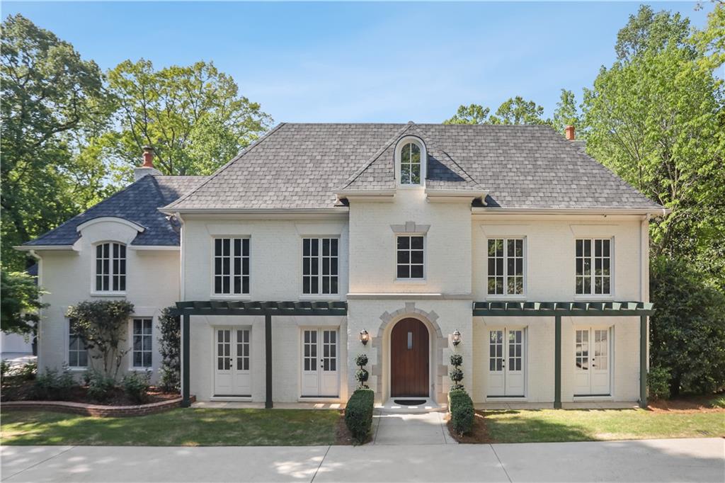a front view of a house with a garden