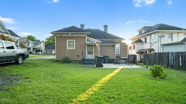 a front view of a house with garden and deck