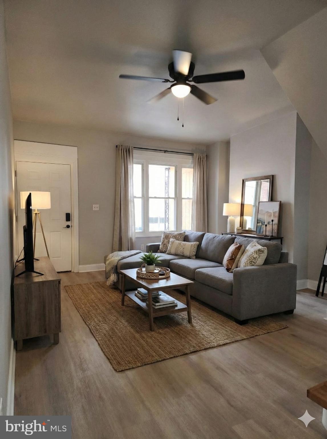 a living room with furniture window and flat screen tv