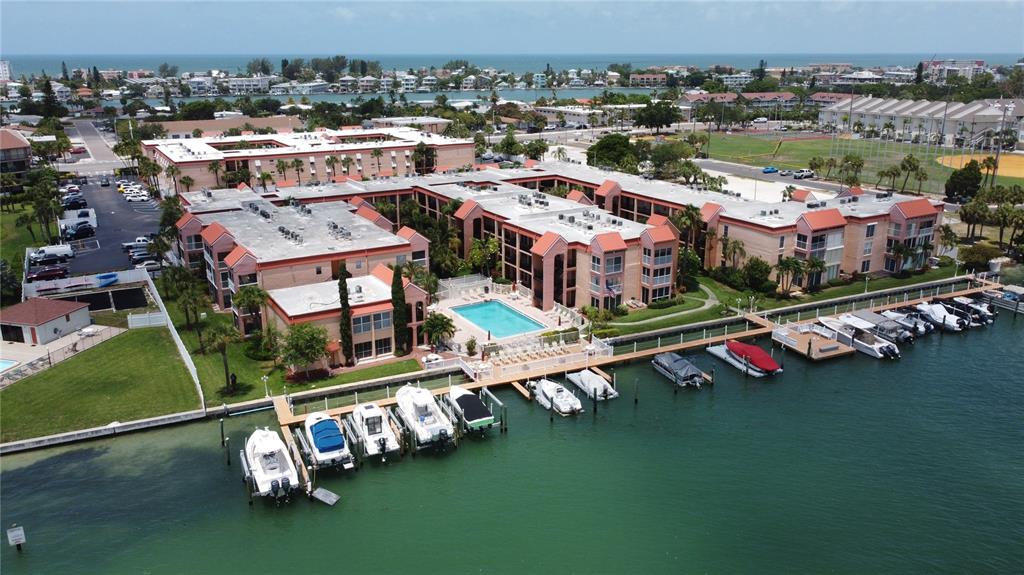 an aerial view of a house with a garden and lake view
