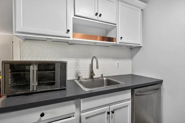 a kitchen with a sink and cabinets