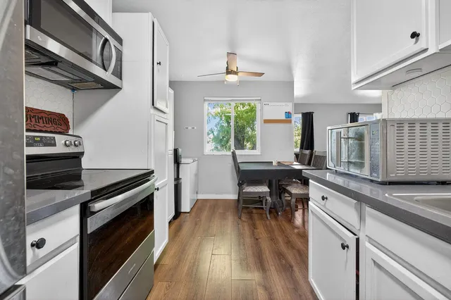 a kitchen with a sink stove and cabinets