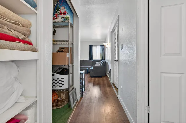 a view of hallway with wooden floor