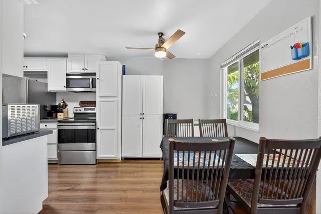 a kitchen with sink cabinets stainless steel appliances and window