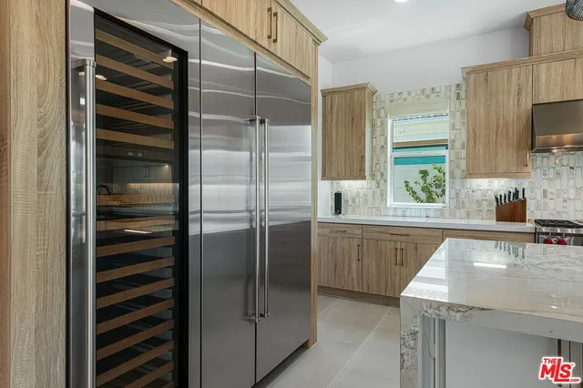 a kitchen with a refrigerator and a sink