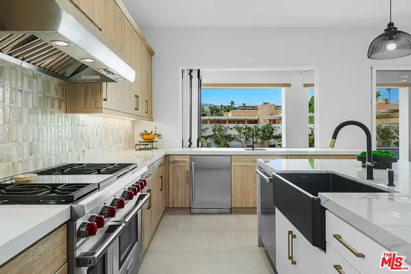 a kitchen with a sink and a stove top oven