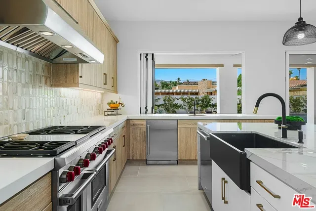 a kitchen with a sink and a stove top oven