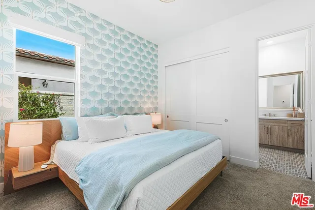 a bedroom with a bed and a dresser