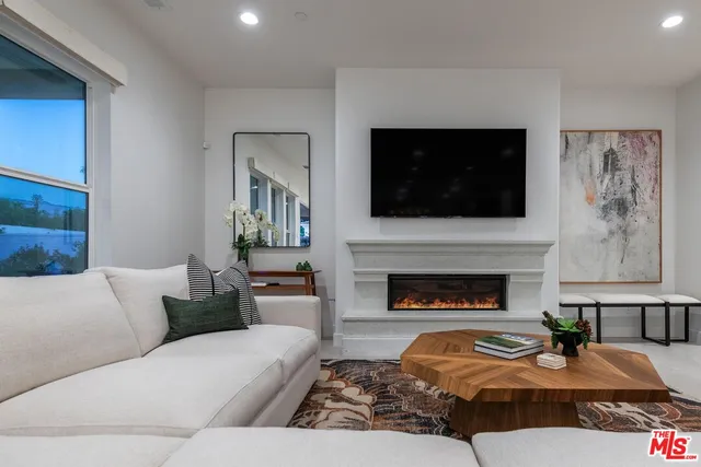 a view of a balcony with dining table and chairs