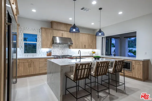 a view of a patio with couches table and chairs and potted plants