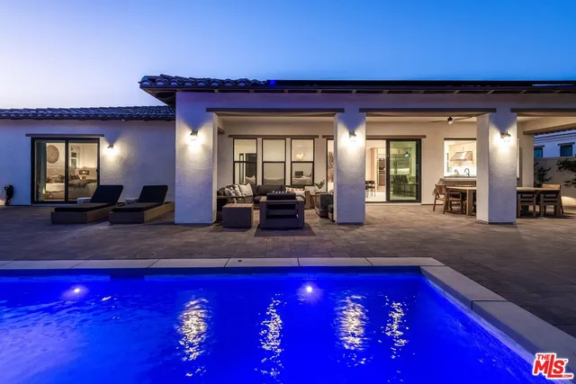 a view of swimming pool with outdoor seating