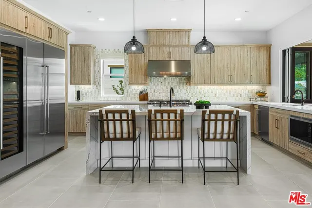 a kitchen with a table chairs refrigerator and microwave